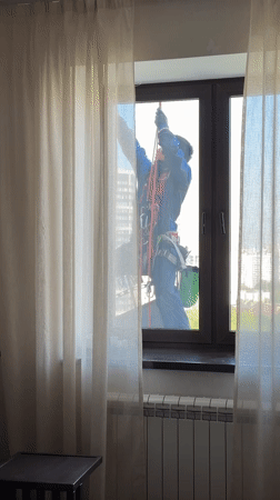 Worker performs high-rise maintenance in Khimki, Russia