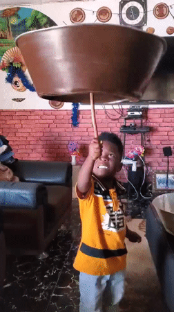 Balancing a large bowl on a stick indoors, living room setting