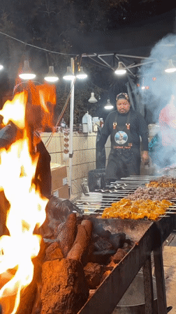 Late-night street grilling over open fire in Los Angeles