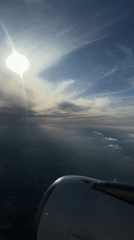 Passenger films sunny aerial view from plane over France