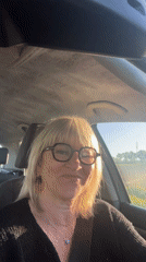 Smiling woman observed driving through Chambœuf, France early morning