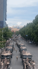 Military convoy moves through Yerevan streets as civilians watch