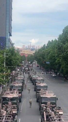 Military convoy moves through Yerevan streets as civilians watch