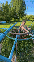 Child plays on playground equipment in Альняш, Russia