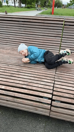 Child plays at playground, rests on benches in Veliky Novgorod