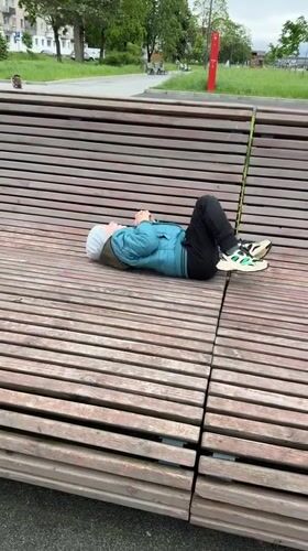 Child plays at playground, rests on benches in Veliky Novgorod