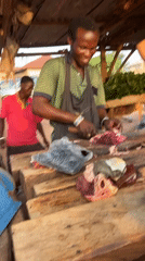 Butcher works cheerfully at meat shop in Abuja