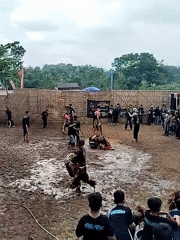 Traditional outdoor cultural performance captured by witnesses in fenced area