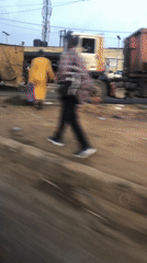 Garbage truck on the move through busy Ikeja street