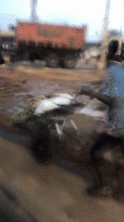 Garbage truck on the move through busy Ikeja street