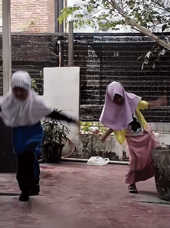 Kids dancing and coffee flowing at a Lhokseumawe outdoor café