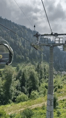 Cable car ride up a forested mountain resort in Estosadok