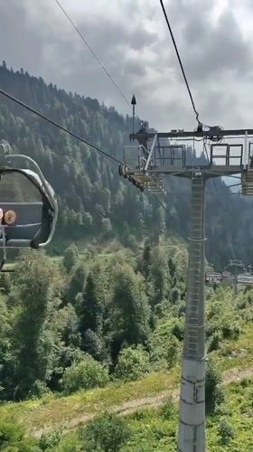 Cable car ride up a forested mountain resort in Estosadok