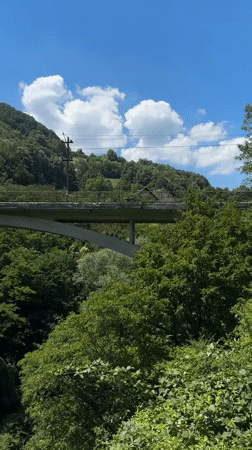 Cliff-side trail and concrete arch bridge near Užice, Serbia