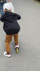 Child rides scooter on path in Tolyatti, Russia