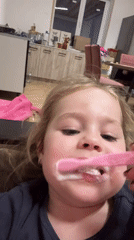 Child brushes teeth with pink toothbrush in Izhevsk
