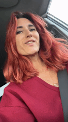 Woman photographed smiling inside car in Ukrainian village