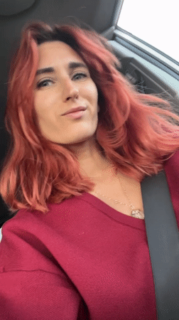 Woman photographed smiling inside car in Ukrainian village