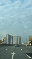 Early morning drive captures Moscow highway with Ferris wheel view