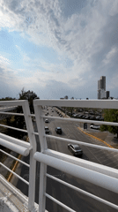 Evening pedestrian overpass views document commercial district in Puebla