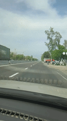 Dashboard view captures woman on Uzbekistan highway