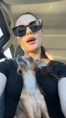 Woman and dog captured in vehicle selfie in Chaykovsky