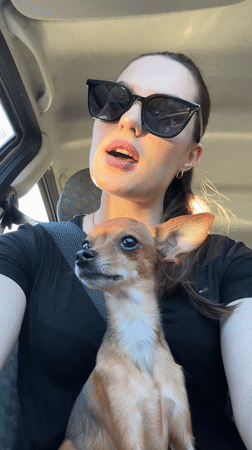 Woman and dog captured in vehicle selfie in Chaykovsky