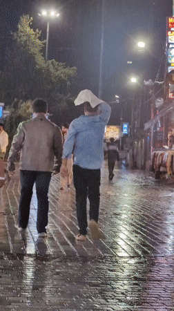 Rainy night on Manali's Mall Road, neon reflections and all
