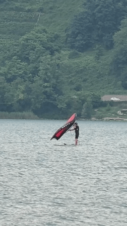 Wing foiling on a mountain lake in northern Italy