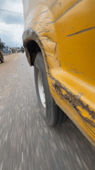 Damaged yellow vehicle spotted on wet road in Nigeria