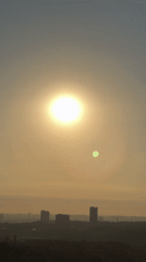 Hazy sunrise over Kyiv's skyline and construction-heavy outskirts