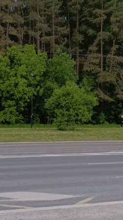 Woman runs alongside road as traffic passes in Perm