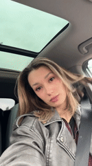 Woman observed in car during brief rainy afternoon moment