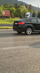 Two cars stopped on wet highway during light hail