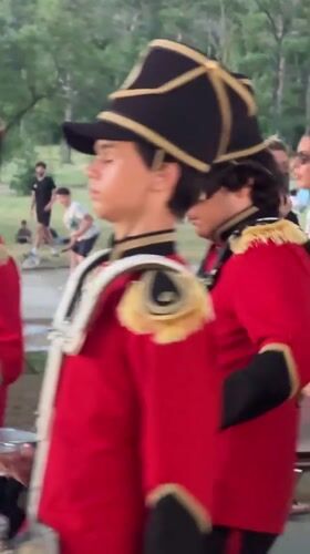 Drumline marches through Tbilisi in red and black uniforms