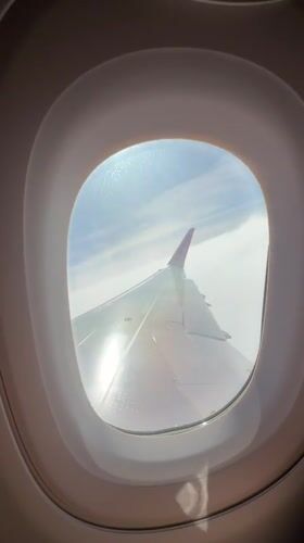 Passenger films Wizz Air wing view during Portugal flight