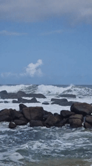 Waves crash against rocky coastline at Dondra, Sri Lanka