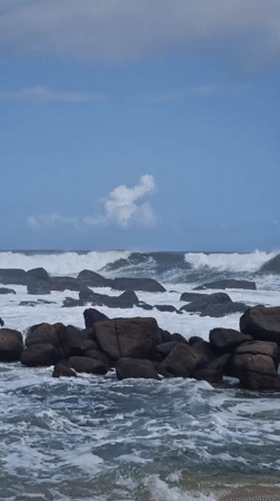 Waves crash against rocky coastline at Dondra, Sri Lanka