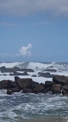 Waves crash against rocky coastline at Dondra, Sri Lanka