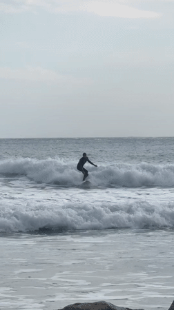 Surfer enjoys session at Hout Bay under overcast skies