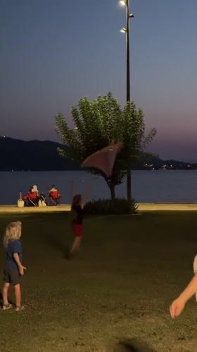 Dusk at Fethiye waterfront, kids on the grass, sky glowing