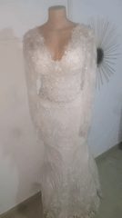 Ornate white wedding dress displayed on mannequin captured