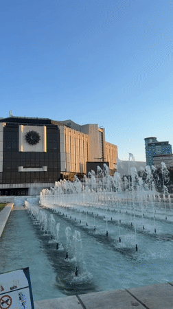 Juggling and fountains outside Sofia's NDK at golden hour