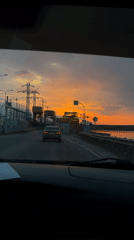 Vehicle journey documented through Chaikovsky, Russia during sunset hours