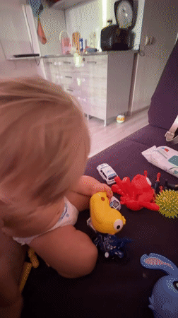 Toddler playtime at home in Sochi, squeegee included