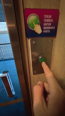 Ferry passenger operates door button near Ketapang, Indonesia