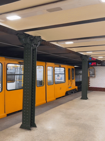 Yellow subway train 31 stops at Budapest underground station