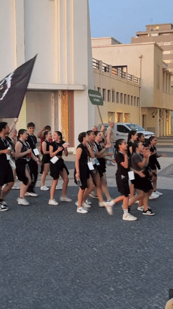 Youth parade procession coincides with sunset at Espinho beach