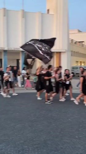 Youth parade procession coincides with sunset at Espinho beach