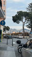 Elderly couple walks Sanremo streets under cloudy skies